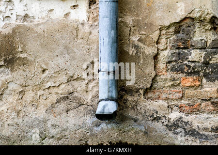 Old grunge wall with rain gutters textured background. Stock Photo