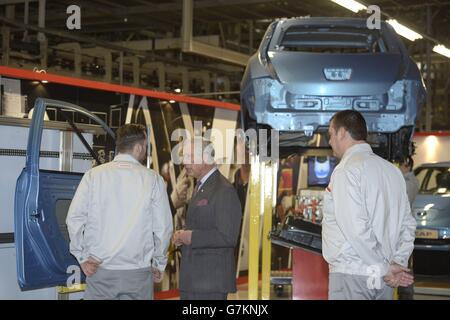 The Prince of Wales talks to workers as he shown the production line of the new electric Leaf cars during a visit to the Nissan UK plant in Sunderland. Stock Photo