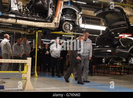 The Prince of Wales talks to workers as he shown the production line of the new electric Leaf cars during a visit to the Nissan UK plant in Sunderland. Stock Photo