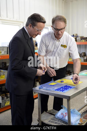 Prime Minister David Cameron is shown some of the products during a visit to Martin's Rubber in Southampton.