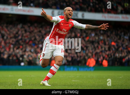 Arsenal's Theo Walcott celebrates scoring his side's third goal during the Barclays Premier League match at the Emirates Stadium, London. Stock Photo