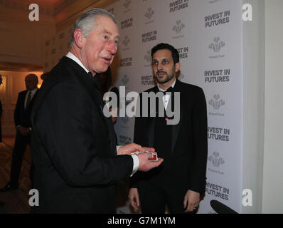 The Prince of Wales takes part in a card trick with magician Dynamo as he attends the annual Prince's Trust 'Invest In Futures' reception at the Savoy Hotel in London. Stock Photo