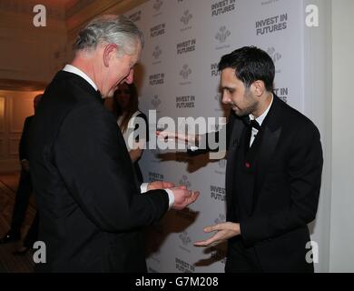 The Prince of Wales takes part in a card trick with magician Dynamo as he attends the annual Prince's Trust 'Invest In Futures' reception at the Savoy Hotel in London. Stock Photo