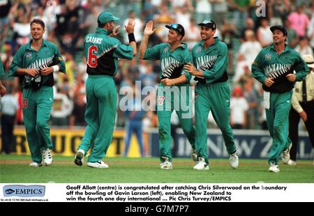 Geoff Allott (centre) is congratulated after catching Chris Silverwood on the boundary off the bowling of Gavin Larson (left) enabling New Zealand to win the fourth one day international. Stock Photo