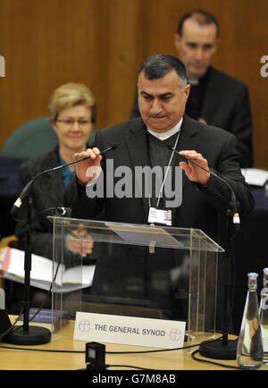 The Archbishop of the Chaldean Diocese of Erbil, Iraq, Bashar Warda, adjusts the microphones as he prepares to give an address during the opening day of the General Synod at Church House, London. RESS ASSOCIATION Photo. Picture date: Tuesday February 10, 2015. See PA story RELIGION Synod. Photo credit should read: Nick Ansell/PA Wire Stock Photo