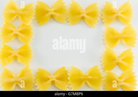 farfalle pasta forming shapes on a white background Stock Photo