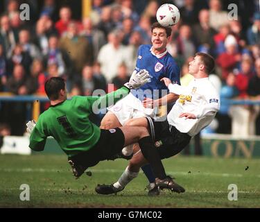 Chris Beaumont, Chesterfield {R} clears the ball from the path of Karl Connelly, Wrexham {C} Stock Photo