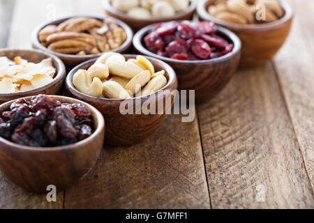 Variety of nuts and dried fruits in small bowls Stock Photo