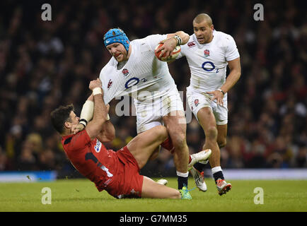 England's James Haskell is tackled by Wales' Mike Phillips (left) during the RBS 6 Nations match at the Millennium Stadium, Cardiff. Stock Photo