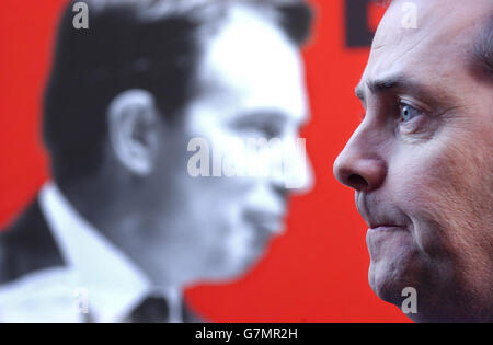 Liam Fox, the Conservative Party co-chairman, infront of a poster showing the infighting within the Labour Party. Stock Photo
