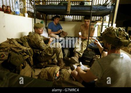 Soldiers from 5 Scots play cards in a dorm at Lab(E) Laikipia Air Base (East) as they prepare with other soldiers from the 2nd Battalion, The Royal Regiment of Scotland, to take part in Exercise Askari Storm on the outskirts of Nanyuki, Kenya. Stock Photo