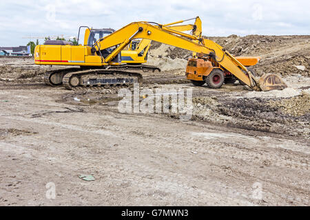 View on excavator with caterpillar who is parked at construction site. Stock Photo