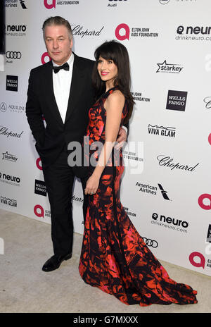 Alec Baldwin and Hilaria Baldwin arrive for the Elton John AIDS Foundation's 23rd annual Academy Awards Viewing Party at West Hollywood Park in Los Angeles. Stock Photo