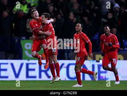 Liverpool's Philippe Coutinho (centre) celebrates with team-mates Alberto Moreno (left) and Raheem Sterling after scoring his side's second goal during the FA Cup Fourth Round Replay at the Macron Stadium, Bolton. PRESS ASSOCIATION Photo. Picture date: Wednesday February 4, 2015. See PA story SOCCER Bolton. Picture credit should read: Peter Byrne/PA Wire. . . Stock Photo