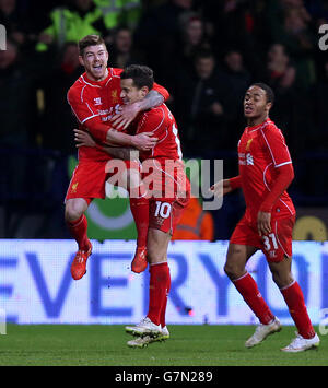 Liverpool's Philippe Coutinho (centre) celebrates with team-mates Alberto Moreno (left) and Raheem Sterling after scoring his side's second goal during the FA Cup Fourth Round Replay at the Macron Stadium, Bolton. PRESS ASSOCIATION Photo. Picture date: Wednesday February 4, 2015. See PA story SOCCER Bolton. Picture credit should read: Peter Byrne/PA Wire. Maximum 45 images during a match. No video emulation or promotion as 'live'. No use in games, competitions, merchandise, betting or single club/player services. No use with unofficial audio, video, data, fixtures or club/league logos. Stock Photo