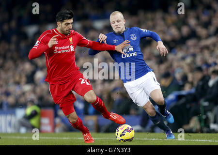 Liverpool's Emre Can (left) and Everton's Steven Naismith (right) battle for the ball. Stock Photo