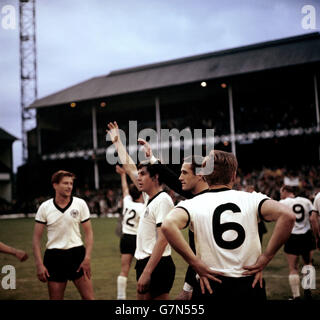 West Germany's Lothar Emmerich (c) and Hans Tilkowski (second r) wave to fans in the crowd after their 2-1 victory Stock Photo