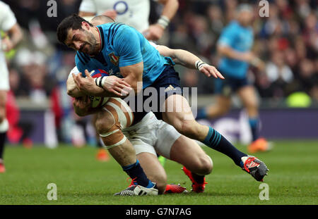 Italy's Andrea Masi is tackled by England's Mike Brown (rear) which resulted in an injury to Mike Brown during the 6 Nations match at Twickenham, London. Stock Photo