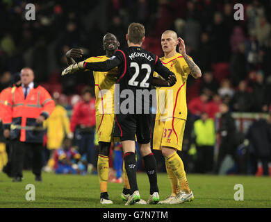 Liverpool's Mamadou Sakho, Simon Mignolet (centre) and Martin Skrtel (right) celebrate after the final whistle during the FA Cup Fifth Round match at Selhurst Park, London. Stock Photo