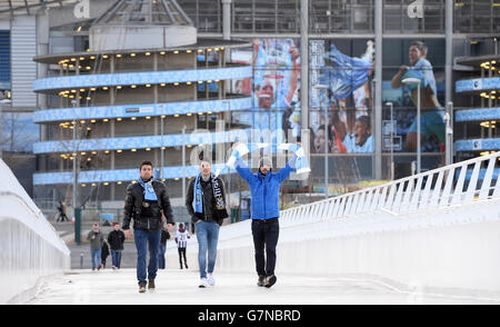 Manchester City fans arrive at The Etihad Stadium before the Barclays Premier League match between Manchester Cityand Newcastle United at the Etihad Stadium, Manchester. Stock Photo