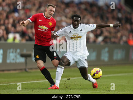 Manchester United's Phil Jones and Swansea City's Bafetimbi Gomis in action during the Barclays Premier League match at the Liberty Stadium, Swansea. PRESS ASSOCIATION Photo. Picture date: Saturday February 21, 2015. See PA story SOCCER Swansea. Photo credit should read: David Davies/PA Wire. Stock Photo