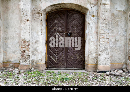 Vintage sprinkled white plaster wall with old door texture background Stock Photo