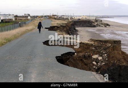 The coastal road south of Bridlington, between Ulrome and Skipsea, shows the rapid pace of erosion with only a small section of the original road left on the cliff tops. Stock Photo