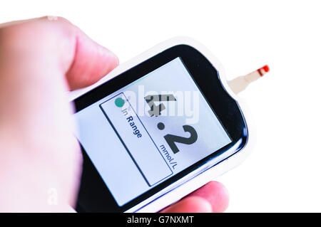Blood glucose monitor showing a glucose level of 4.2mmol/L, within the normal range of 4.0 to 5.9 mmol/L under normal conditions Stock Photo