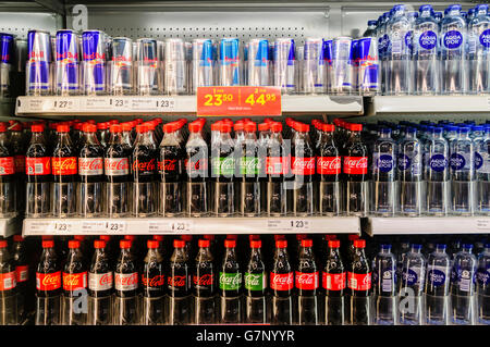 Coca cola (ordinary, diet/light/lite, and life) with Red Bull energy drinks and bottled water for sale in a shop in Denmark. Stock Photo