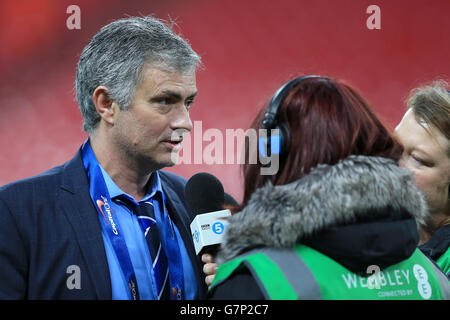 Chelsea manager Jose Mourinho (left) is interviewed by Radio 5 Live after his team win the Capital One Cup Final. Stock Photo