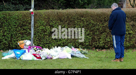 A man bows his head for a moment after laying flowers at the main gate of RAF Lyneham, following the death of 10 service personnel who were killed when an RAF Hercules crashed into the Iraqi desert on Sunday. Stock Photo