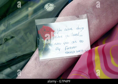 A message accompanies flowers at the main gate of RAF Lyneham, following the death of 10 service personnel who were killed when an RAF Hercules crashed into the Iraqi desert on Sunday. Stock Photo