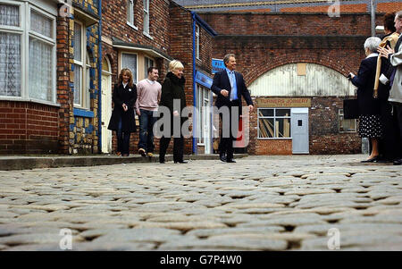 British Prime Minister Tony Blair walks across the famous cobbles of the Coronation Street set with actress Liz Dawn who plays Vera Duckworth in the television soap. Stock Photo