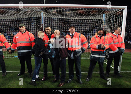 Soccer - FA Cup - Sixth Round - Aston Villa v West Bromwich Albion - Villa Park. Aston Villa fans have a photo taken with stewards as they invade the pitch after the FA Cup Sixth Round match at Villa Park, Birmingham. Stock Photo