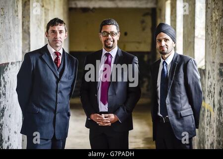 Welsh Deputy Health Minister, Vaughan Gething (centre), Dr Rhys Thomas (left) and Dr Dindi Gill (right) during a break in a live multi-agency training exercise near Newport in Wales. Stock Photo