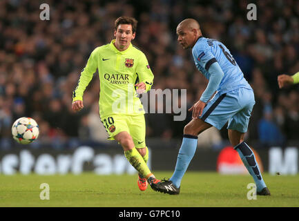 Soccer - UEFA Champions League - Round of 16 - First Leg - Manchester City v Barcelona - Etihad Stadium. Barcelona's Lionel Messi and Manchester City's Francisco Fernando battle for the ball Stock Photo