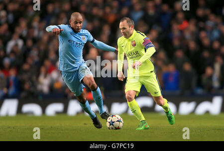 Soccer - UEFA Champions League - Round of 16 - First Leg - Manchester City v Barcelona - Etihad Stadium. Manchester City's Francisco Fernando and Barcelona's Andres Iniesta battle for the ball Stock Photo