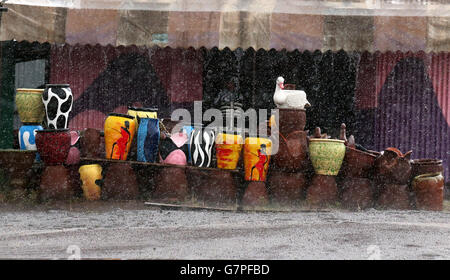 Pots for sale as Kenyans going about their daily life near the town of Nairobi . Stock Photo