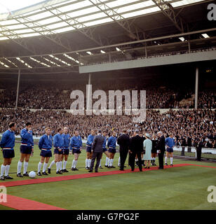 HRH Queen Elizabeth II (fourth r) is introduced to the England team by FIFA President Sir Stanley Rous (second r) before the opening match of the Finals. The England players are (l-r) George Cohen, Gordon Banks, Alan Ball, Ray Wilson, Bobby Charlton, Nobby Stiles, Roger Hunt, John Connelly, Jimmy Greaves, Jack Charlton (hidden), Bobby Moore (far r) Stock Photo