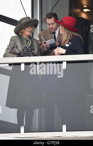 The Duchess of Cornwall (left) watches the RSA Chase with son Tom Parker-Bowles (centre) and daughter Laura Lopes (right) on Ladies Day during the Cheltenham Festival at Cheltenham Racecourse. Stock Photo