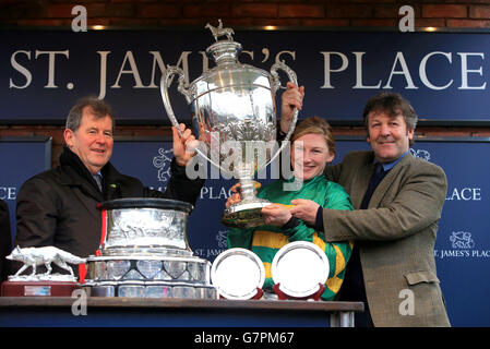 Jockey Nina Carberry and owner JP McManus (left) with the trophy after On The Fringe wins the St. James's Place Foxhunter Chase Challenge Cup on Gold Cup Day during the Cheltenham Festival at Cheltenham Racecourse. PRESS ASSOCIATION Photo. Picture date: Friday March 13, 2015. See PA story RACING Cheltenham. Picture credit should read: Nick Potts/PA Wire. Stock Photo