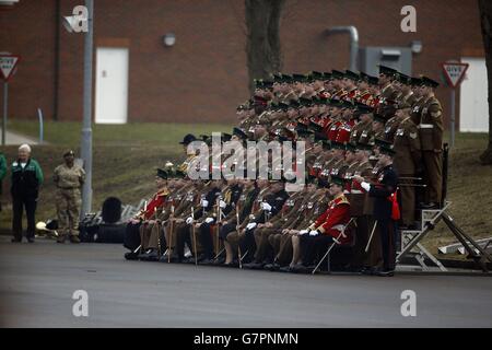 The Duke and Duchess of Cambridge (eighth left and eighth right) have their photograph taken with members of the 1st Battalion Irish Guards at the St. Patrick's Day Parade at Mons Barracks, Aldershot, Hampshire, to mark St Patrick's Day today. Stock Photo