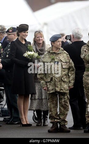 The Duchess of Cambridge poses for a photograph as she meets veterans and cadets during a visit to the 1st Battalion Irish Guards at the St. Patrick's Day Parade at Mons Barracks, Aldershot, Hampshire, to mark St Patrick's Day today. Stock Photo