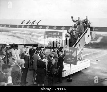 The first passengers to travel on a regular jet airliner service from London to New York go aboard the Comet 4 at London Airport. Notice boards proclaim BOAC's victory in the race to provide the first Transatlantic jet service. The Comet flight comes well ahead of the date announced by Pan American Airways for the start of their Boeing 707 jet service. Stock Photo