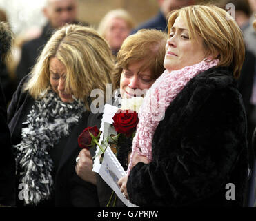 Teresea Keightley (centre), mother of Conor Keightley, killed in the Indian Ocean tsunami, is comforted by her two daughters, Michelle (left) and Darina, after his funeral mass. Stock Photo