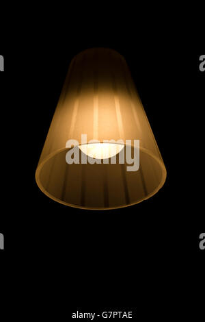 Lamp with bulb shining in the darkness. Stock Photo