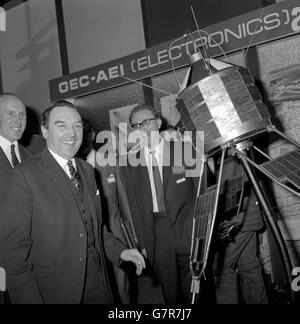 A cheerful Postmaster General, Roy Mason (l) with a scale model of the first all-British satellite, Ariel 3, which has now been successfully orbiting for a full year, when he toured the exhibition in connection with the seminar on the planning and operation of communication satellite earth stations which he opened at the Royal Lancaster Hotel, London. With Mr Mason is D. M. Kettle (r), commercial manager of GEC-AEI Electronics Ltd. More then 50 countries are represented by some 250 participants in the seminar, which is sponsored by the Post Office, The Ministry of Technology and British Stock Photo