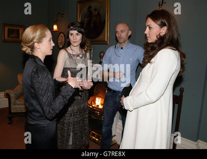 The Duchess of Cambridge chats to actress Michelle Dockery (Lady Mary Crawley) and Joanne Froggatt (Anna Bates) during an official visit to the set of Downton Abbey at Ealing Studios in London. Stock Photo