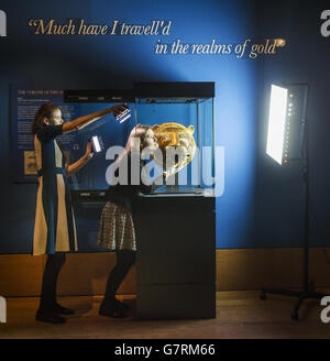 Exhibition Curator Lauren Porter (right) with a golden Tiger's head which was part of the throne of Tipu Sultan (1750-99), ruler of Mysore, India, which forms part of the Gold exhibition at the The Queen's Gallery at the Palace of Holyroodhouse in Edinburgh. Stock Photo