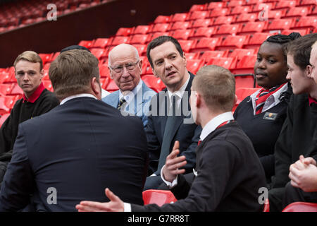 Chancellor of the Exchequer George Osborne (centre) and former England midfielder, Sir Bobby Charlton (third left) during a meeting with apprentices at Manchester United Football Club, in Trafford Park. Stock Photo